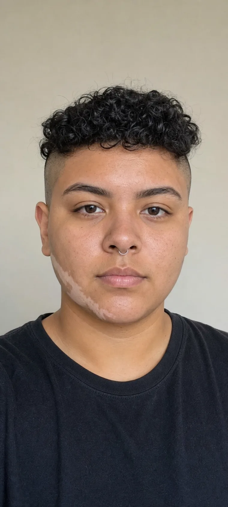 Synthetic source portrait for case 16, a 22-year-old Latino nonbinary person